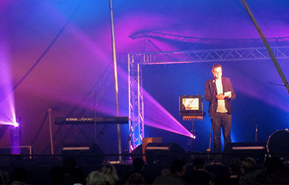 Alexander May performing magic on stage in Upington